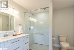 Bathroom with walk in shower, vanity, and toilet - 