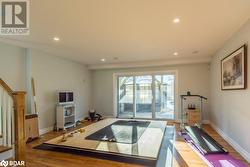 Exercise room featuring hardwood / wood-style floors - 