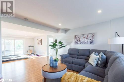 Living room featuring wood-type flooring - 1647 Lakeside Drive, Hillier, ON - Indoor Photo Showing Living Room