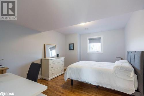 Bedroom featuring dark hardwood / wood-style floors - 1647 Lakeside Drive, Hillier, ON - Indoor Photo Showing Bedroom