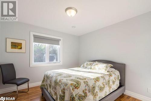 Bedroom with wood-type flooring - 1647 Lakeside Drive, Hillier, ON - Indoor Photo Showing Bedroom