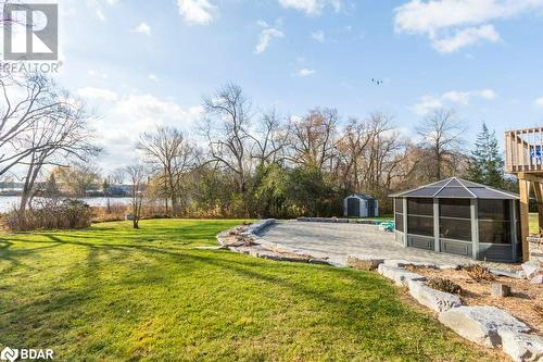 View of yard featuring a water view and a storage unit - 1647 Lakeside Drive, Hillier, ON - Outdoor