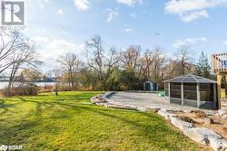 View of yard featuring a water view and a storage unit - 