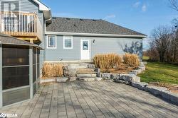 Rear view of house with a patio and a sunroom - 