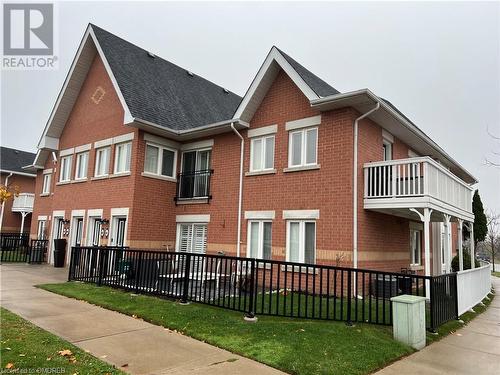 View of side of property with a lawn and a balcony - 1701 Lampman Avenue Unit# 601, Burlington, ON - Outdoor