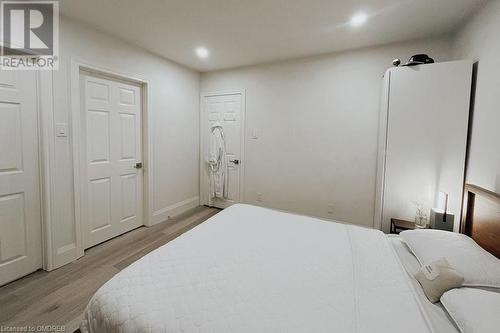 Ensuite bathroom featuring vanity, a shower with shower door, tile patterned floors, and toilet - 1701 Lampman Avenue Unit# 601, Burlington, ON - Indoor Photo Showing Bedroom