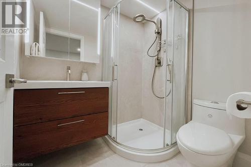 Ensuite bathroom featuring vanity, a shower with shower door, tile patterned floors, and toilet - 1701 Lampman Avenue Unit# 601, Burlington, ON - Indoor Photo Showing Bathroom