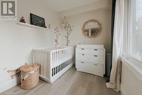 Bedroom with a crib and light hardwood / wood-style floors - 1701 Lampman Avenue Unit# 601, Burlington, ON - Indoor Photo Showing Bedroom