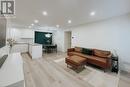 Living room featuring light hardwood / wood-style floors and a chandelier - 1701 Lampman Avenue Unit# 601, Burlington, ON  - Indoor 