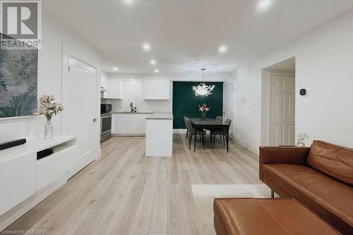 Living room with light hardwood / wood-style flooring and sink - 1701 Lampman Avenue Unit# 601, Burlington, ON - Indoor Photo Showing Living Room