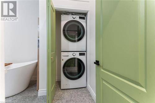 Washroom featuring stacked washing maching and dryer - 50 Ontario Street, Brantford, ON - Indoor Photo Showing Laundry Room