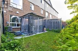 View of yard with central air condition unit and a sunroom - 