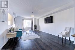 Sitting room featuring dark hardwood / wood-style floors - 