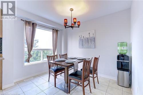 Dining space featuring a chandelier and light tile patterned floors - 151 Green Road S Unit# 26, Stoney Creek, ON - Indoor Photo Showing Dining Room