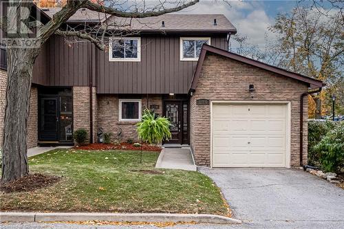 View of front of house featuring a garage and a front yard - 2301 Cavendish Drive Unit# 106, Burlington, ON - Outdoor