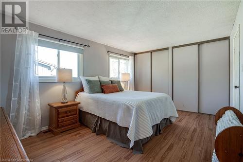 Primary bedroom with wall to wall closets - 2301 Cavendish Drive Unit# 106, Burlington, ON - Indoor Photo Showing Bedroom