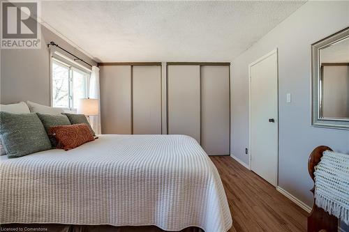 Primary bedroom with wall to wall closets - 2301 Cavendish Drive Unit# 106, Burlington, ON - Indoor Photo Showing Bedroom