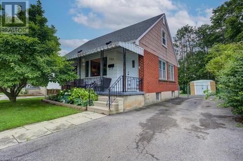 View of front of house featuring covered porch, a storage unit, and a front lawn - 177 Ontario Street, Brantford, ON - Outdoor