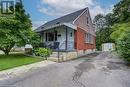 View of front of house featuring covered porch, a storage unit, and a front lawn - 177 Ontario Street, Brantford, ON  - Outdoor 