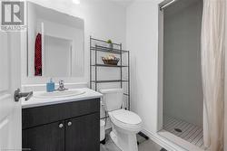 Bathroom with tile patterned flooring, vanity, toilet, and a shower with curtain - 