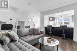 Living room featuring dark wood-type flooring - 