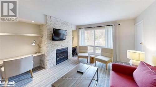 51-208 - 1235 Deerhurst Drive, Huntsville (Chaffey), ON - Indoor Photo Showing Living Room With Fireplace