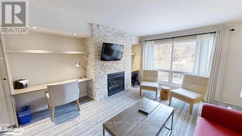 51-208 - 1235 Deerhurst Drive, Huntsville (Chaffey), ON - Indoor Photo Showing Living Room With Fireplace