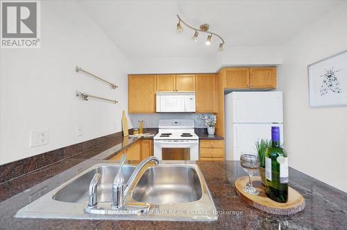 702 - 4080 Living Arts Drive, Mississauga, ON - Indoor Photo Showing Kitchen With Double Sink