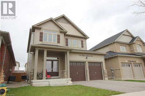 Craftsman house featuring a front lawn, a garage, and a porch - 96 Elliot Avenue E, Fergus, ON - Outdoor With Facade