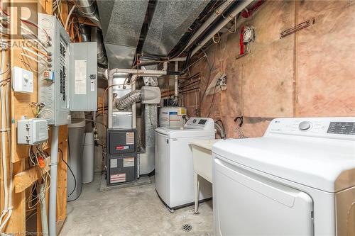 Laundry area with washing machine and clothes dryer and electric water heater - 169 Bismark Drive Unit# 32, Cambridge, ON - Indoor Photo Showing Laundry Room