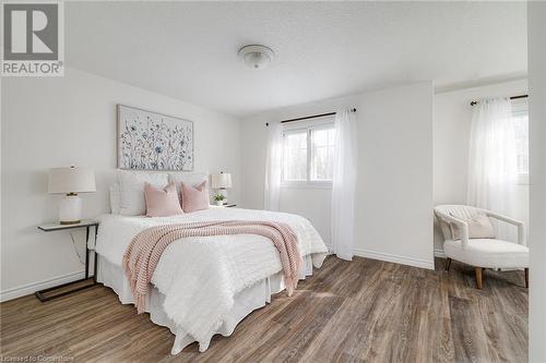 Bedroom with hardwood / wood-style flooring and a textured ceiling - 169 Bismark Drive Unit# 32, Cambridge, ON - Indoor Photo Showing Bedroom