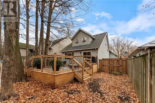 Rear view of property featuring a wooden deck - 54 Pembers Pass, Woodstock, ON 