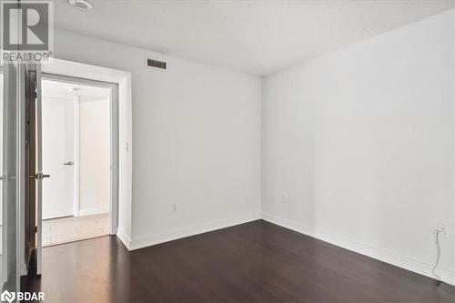 Spare room featuring dark wood-type flooring - 15 Brunel Court Unit# 201, Toronto, ON 