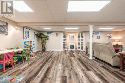 Recreation room with hardwood / wood-style flooring and a paneled ceiling - 5 Twentyplace Boulevard, Mount Hope, ON 