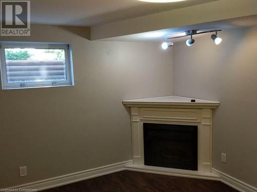 Unfurnished living room featuring dark hardwood / wood-style floors - 319 Bunting Road Unit# #Lower, St. Catharines, ON 