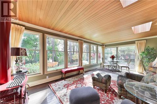 Sunroom / solarium featuring wooden / ceiling and a skylight / gas decorative stove - 218 Northshore Boulevard W, Burlington, ON 