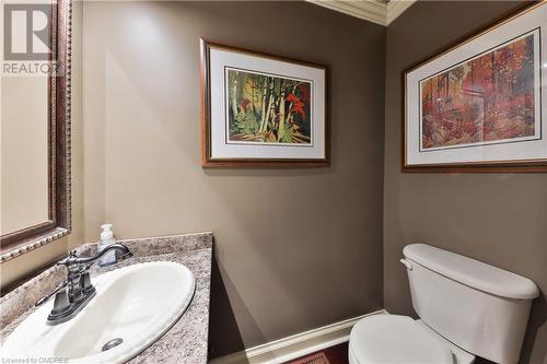 Bathroom featuring vanity, toilet, and ornamental molding - 218 Northshore Boulevard W, Burlington, ON 