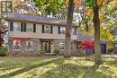 View of front facade featuring a garage and a front lawn - 218 Northshore Boulevard W, Burlington, ON 