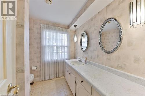 Bathroom featuring toilet, vanity, and tile patterned flooring - 218 Northshore Boulevard W, Burlington, ON 