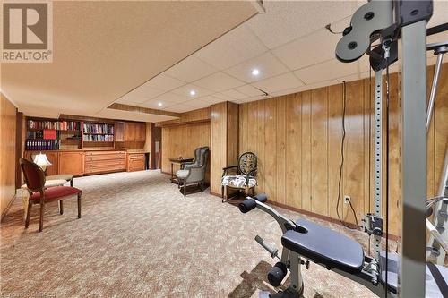 Exercise room with carpet, a paneled ceiling, and wood walls - 218 Northshore Boulevard W, Burlington, ON 