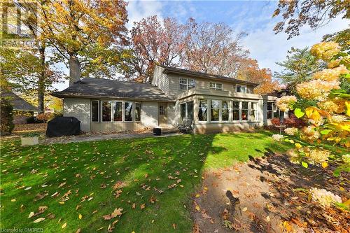 Back of house with a sunroom and a yard - 218 Northshore Boulevard W, Burlington, ON 