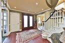 Foyer with french doors, crown molding, and dark hardwood / wood-style flooring - 218 Northshore Boulevard W, Burlington, ON 