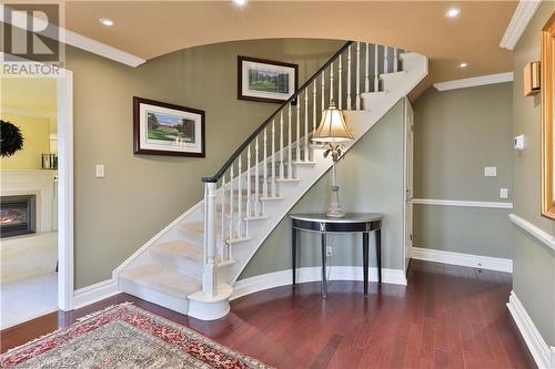 Stairway featuring wood-type flooring and crown molding - 218 Northshore Boulevard W, Burlington, ON 