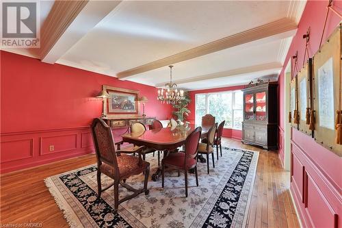 Dining room featuring hardwood / wood-style floors, a notable chandelier, ornamental molding, and beam ceiling - 218 Northshore Boulevard W, Burlington, ON 