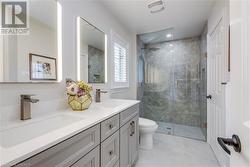 Bathroom with walk in shower, vanity, and toilet - 