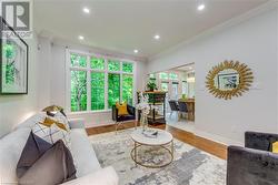 Living room with ornamental molding and light wood-type flooring - 