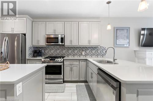 Kitchen featuring decorative light fixtures, tasteful backsplash, sink, and stainless steel appliances - 466 Normanton Street, Port Elgin, ON - Indoor Photo Showing Kitchen With Double Sink With Upgraded Kitchen