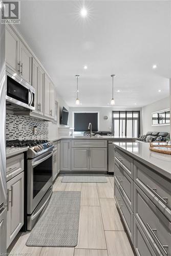 Kitchen featuring pendant lighting, gray cabinets, stainless steel appliances, and tasteful backsplash - 466 Normanton Street, Port Elgin, ON - Indoor Photo Showing Kitchen With Upgraded Kitchen