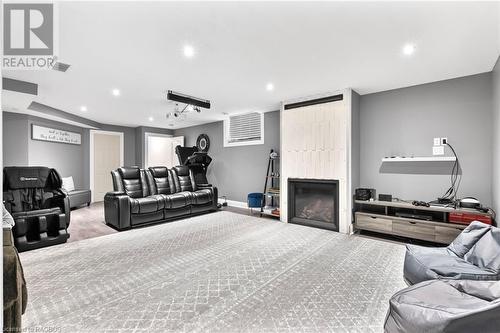 Carpeted living room featuring a large fireplace - 466 Normanton Street, Port Elgin, ON - Indoor With Fireplace