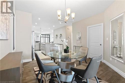 Dining area featuring dark hardwood / wood-style floors and a notable chandelier - 466 Normanton Street, Port Elgin, ON - Indoor Photo Showing Dining Room